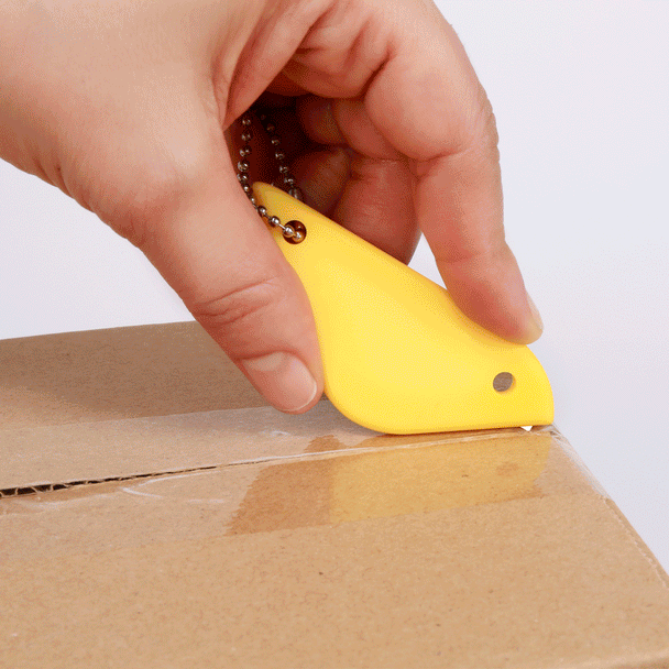 video of a persons hand using the yellow birdy box cutter to open a box