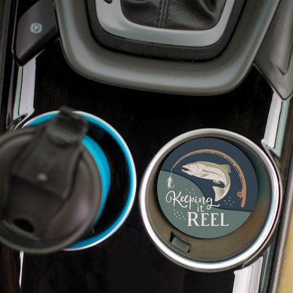 top view of the keeping it reel car coaster displayed in the cup holder in a car