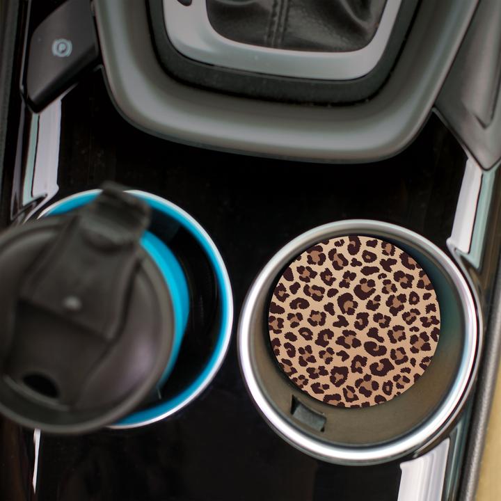 top view of the cheetah car coaster displayed in the cup holder in a car
