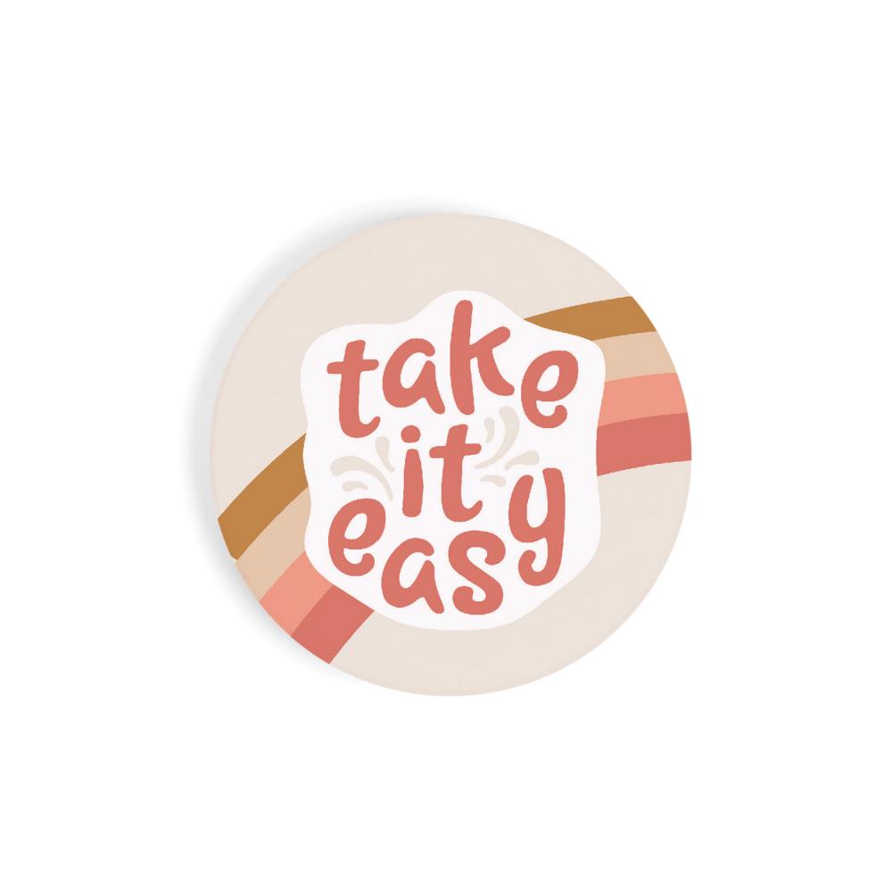 take it easy car coaster is beige with a rainbow in hues of pink and text in dark pink displayed on a white background