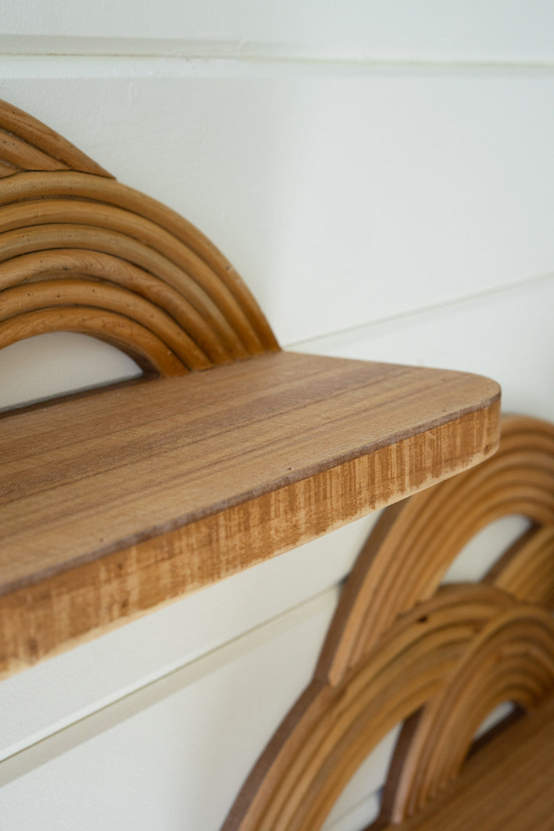 angled view of the arched wooden wall shelves on a white shiplap wall