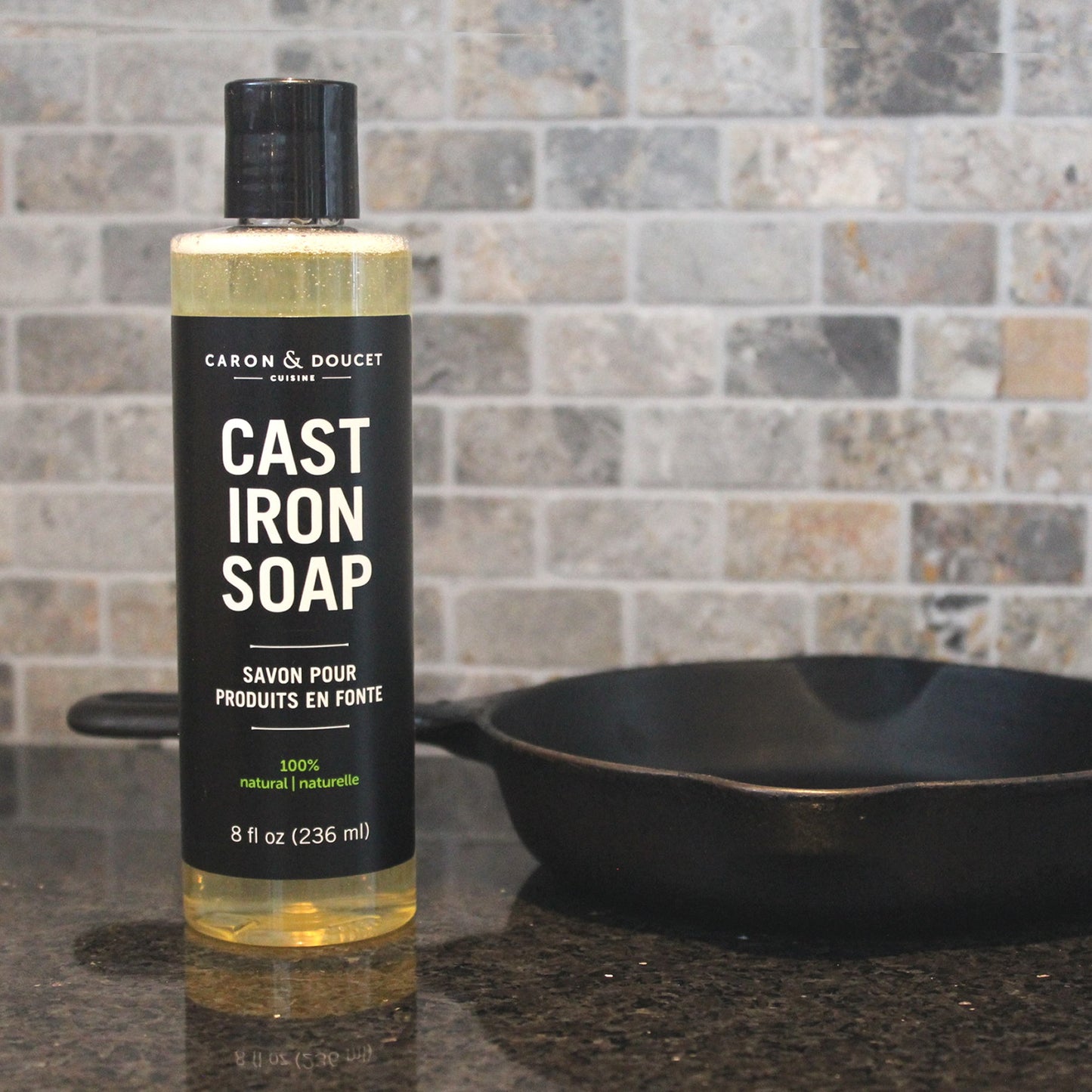 cast iron cleaning soap displayed on a counter beside a cast iron skillet