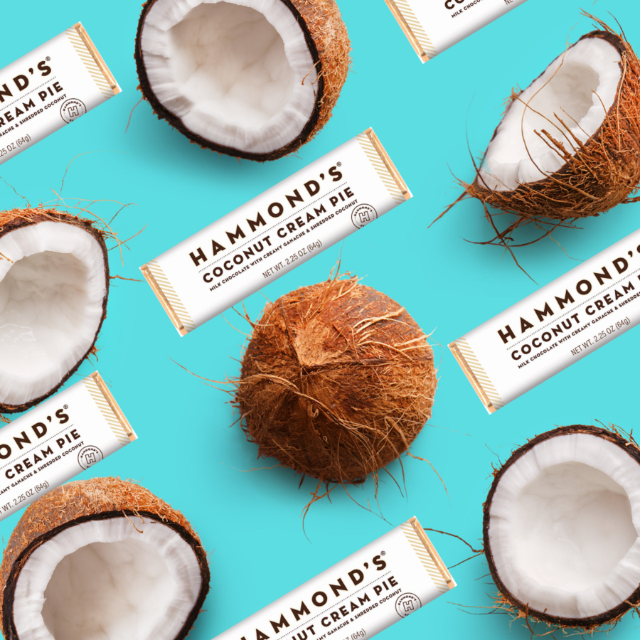 multiple coconut cream pie milk chocolate bars and coconuts displayed on a turquoise background