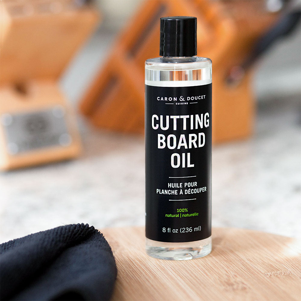 the cutting board conditioning oil displayed on a cutting board in a kitchen