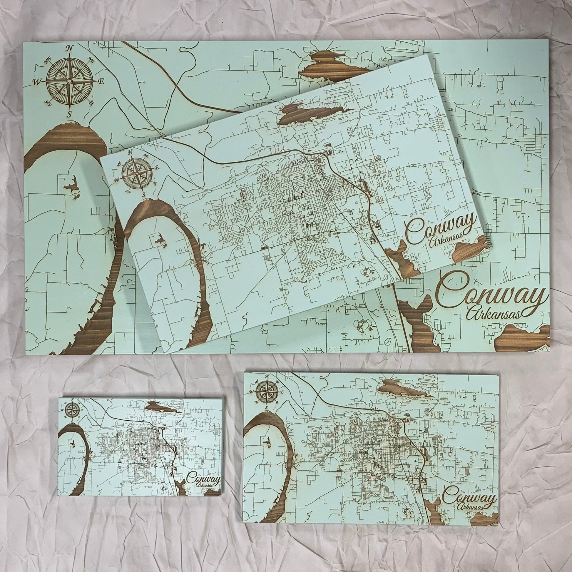 aqua burnt wood map of conway displaying four sizes on a white background