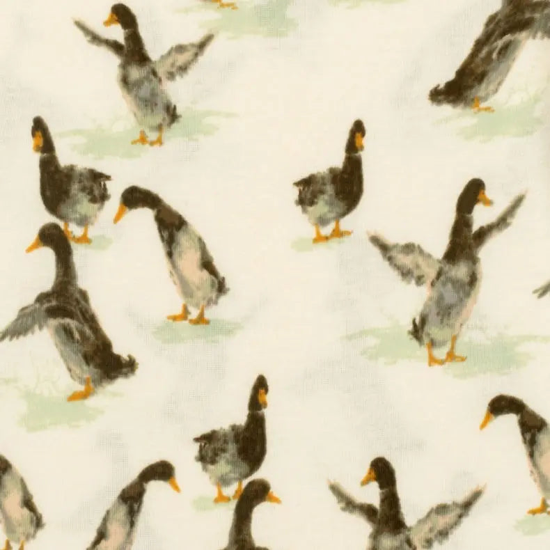 close-up of cream fabric with all-over duck pattern.