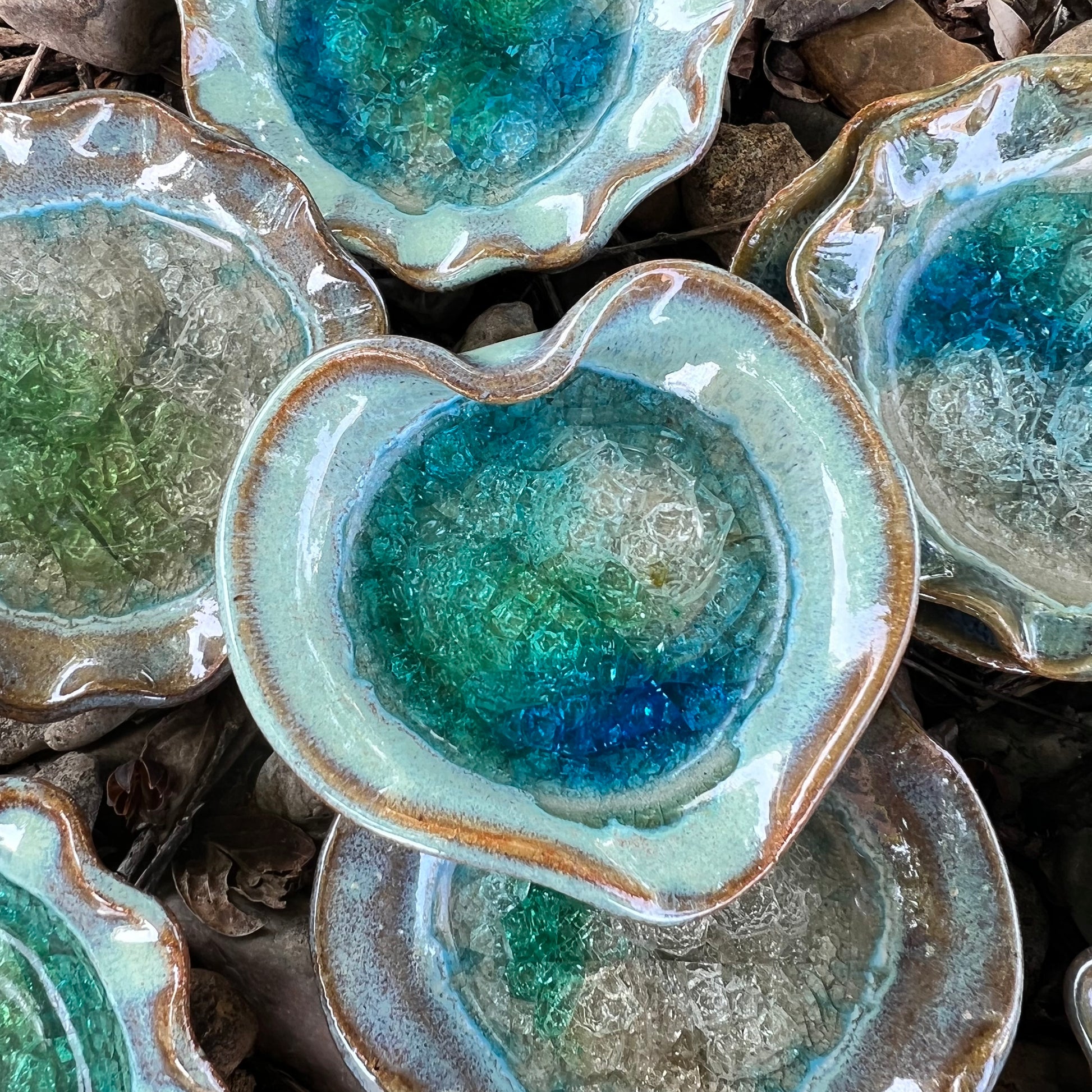 heart minty greens crackled glass little dish displayed with round crackled glass little dish on a bed of leaves and rocks