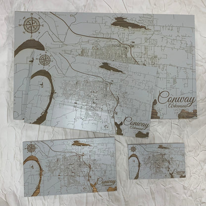 grey burnt wood map of conway displaying four sizes on a white background