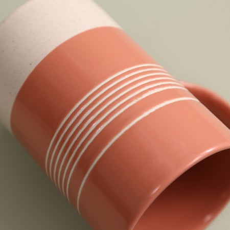 close-up of pink mug with lines around it.