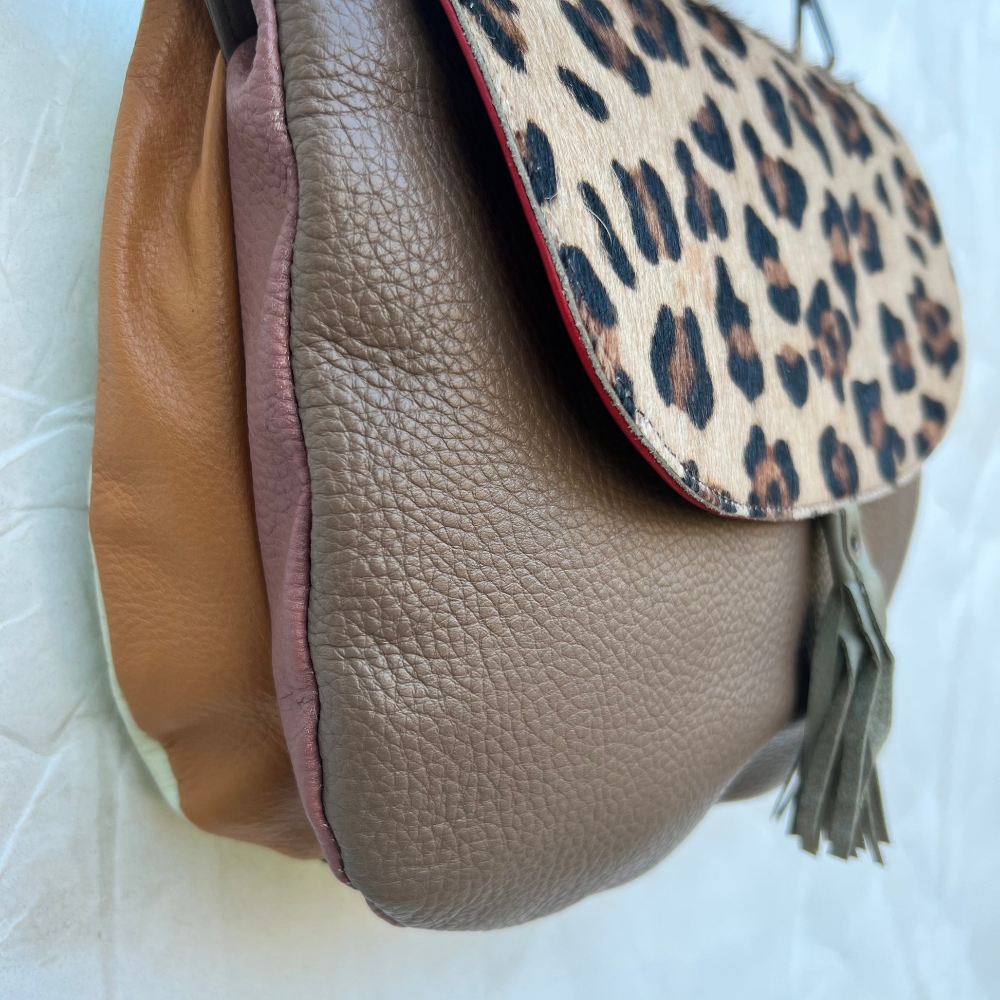 side view of purse showing camel and blush gusset.