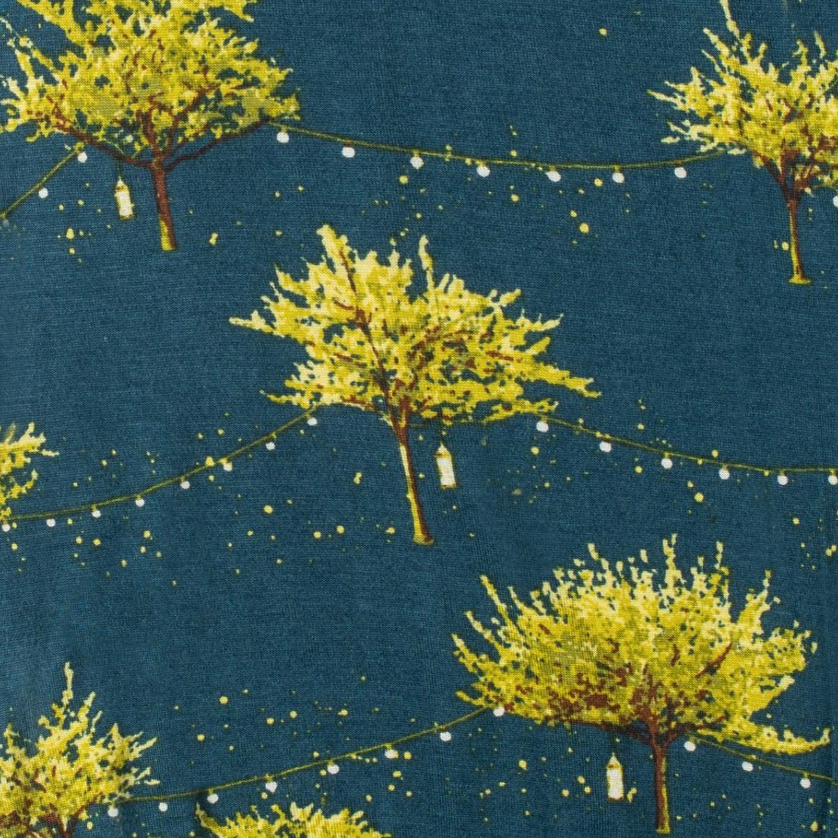 close-up of blue fabric with all-over pattern of trees and fireflies.