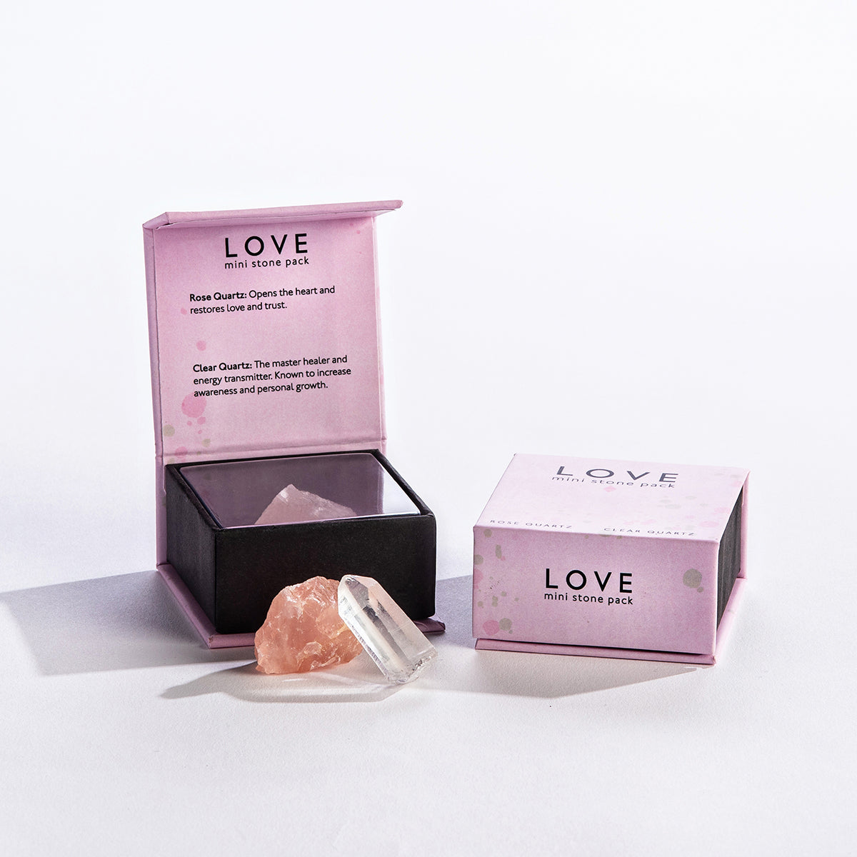 the love mini stones displayed next to the packages on a white background