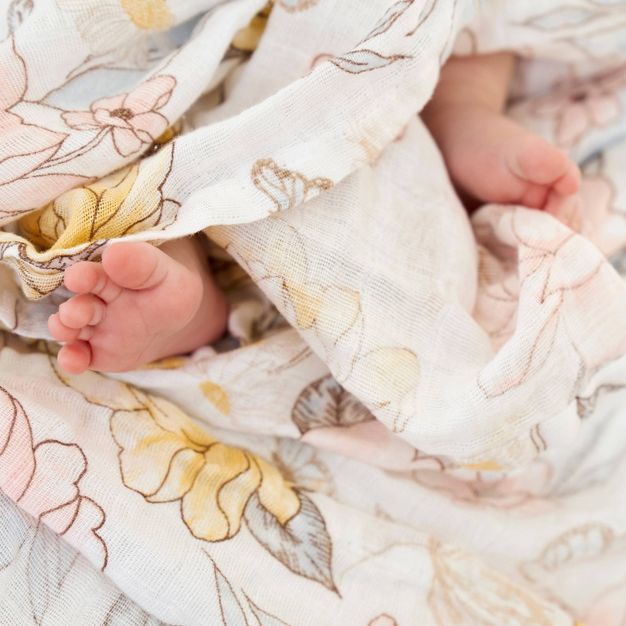 baby feet surrounded by cotton muslin swaddle