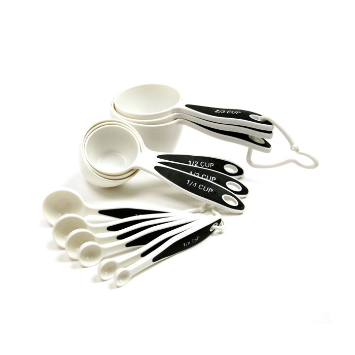white measuring cups and spoons with black handles printed with measurements.