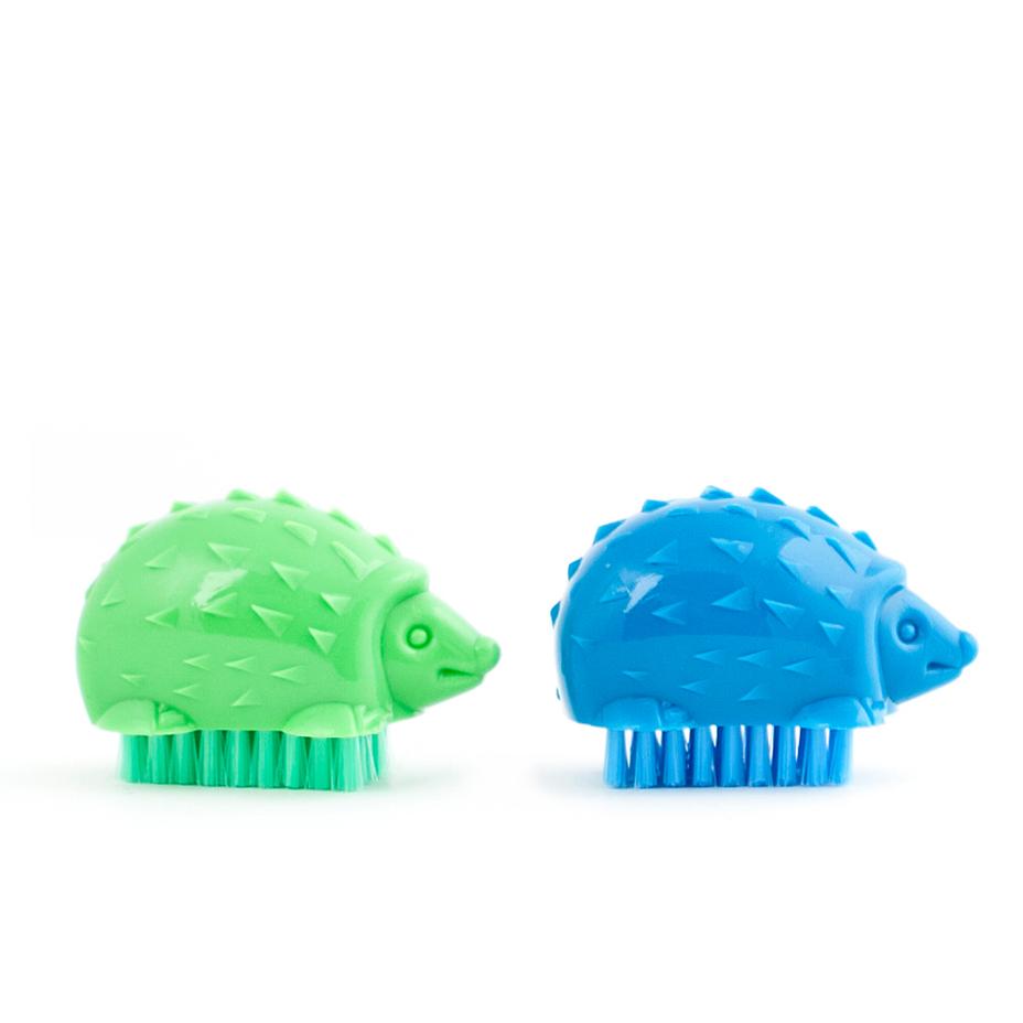 green and blue hedgehog nail brush on a white background