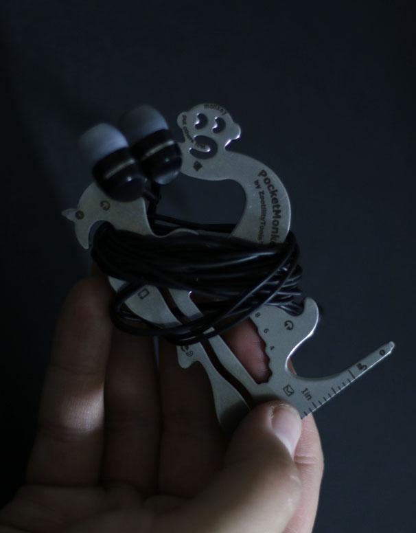 PocketMonkey tool with earphones wrapped around it.