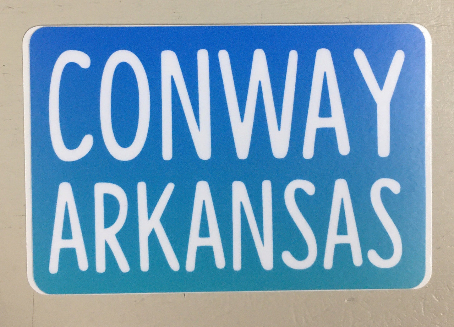 sticker on white background. sticker has blue background "conway arkansas" in white capital letters.