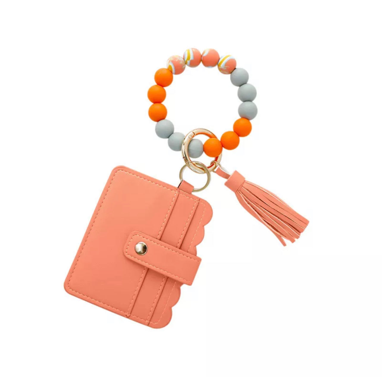colorful silicone bracelet with melon colored wallet and tassel attached to it.