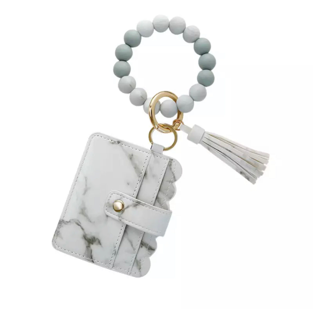 colorful silicone bracelet with white marble wallet and tassel attached to it.