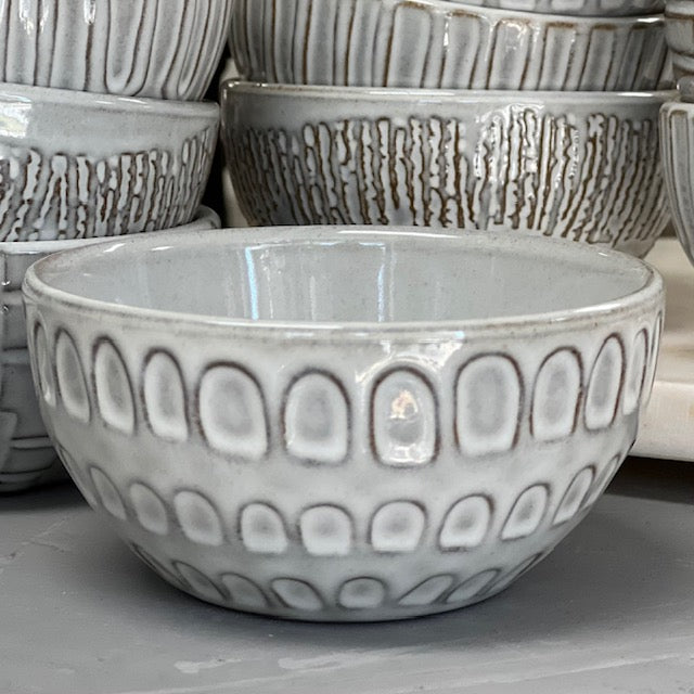 windows patterned stoneware bowls displayed in front of multiple patterned stoneware bowls on a white surface