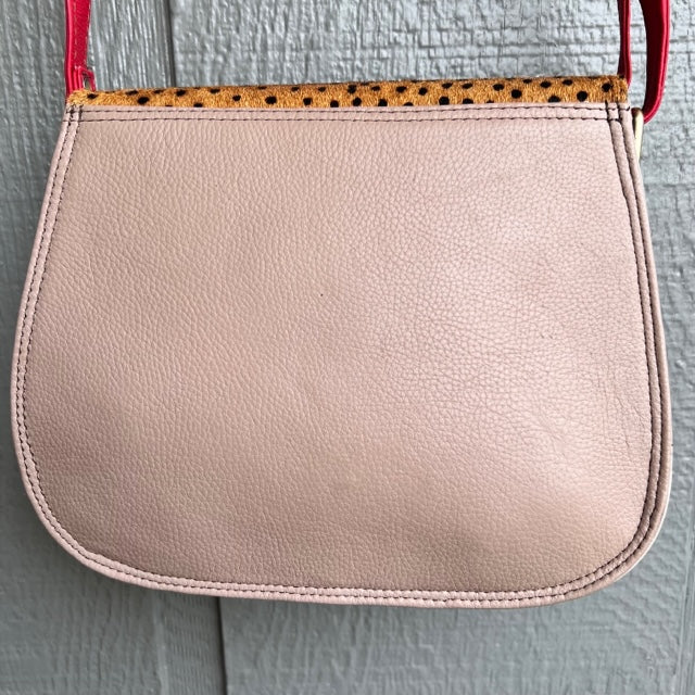 solid taupe back of purse with red strap.