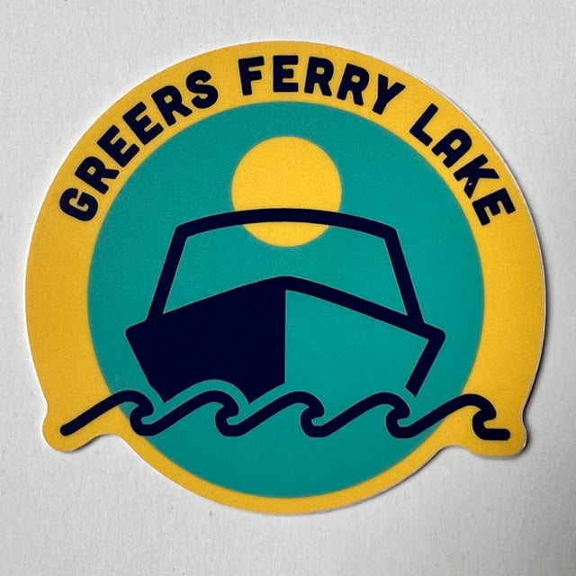 sticker on white background. sticker has blue circle in the middle with graphic of speed boat, waves, and a yellow sun. sticker has yellow boarder with the words "greers ferry lake" along the top.