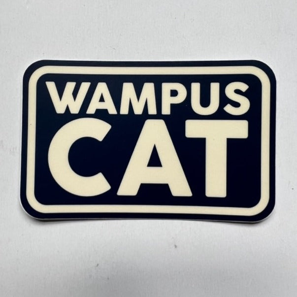 sticker on white background. sticker has blue background and the stacked words "wampus cat" in off-white with an off-white boarder.