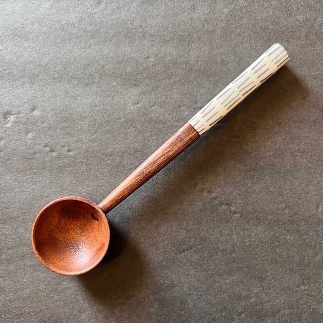 lines handle wooden spoon on a gray background