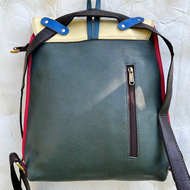Forest green back of backpack with side zipper and brown straps.