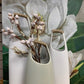 all three size stoneware vases with wrapped handles with a floral print in the background