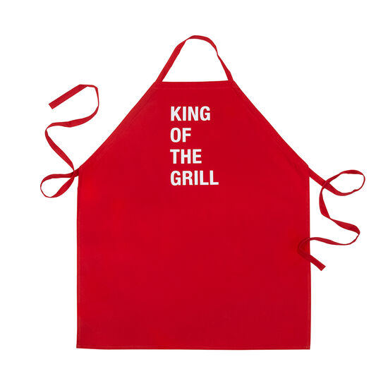 red grill apron with white text "king of the grill" against a white background