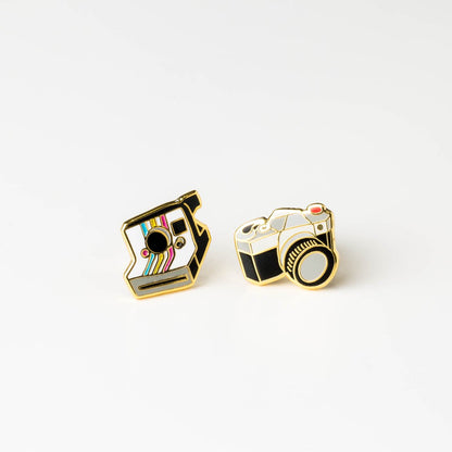pair of camera earrings on white background.