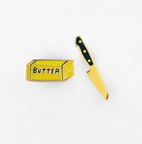 earrings in the shape of a stick of butter and a knife.