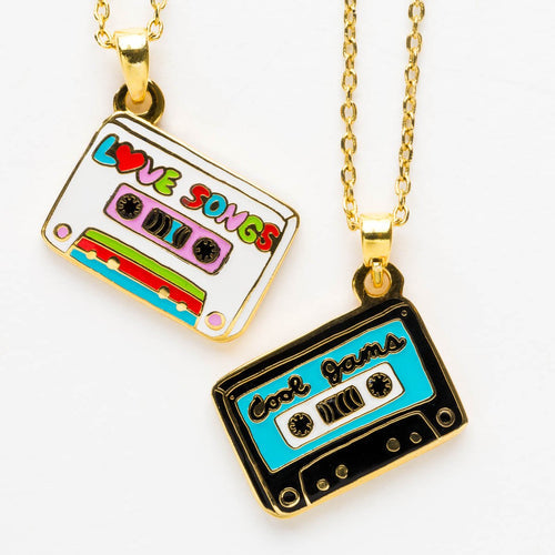 both sides of a necklace pendant shaped like a cassette tape, one side said "love songs" the other "cool jams".