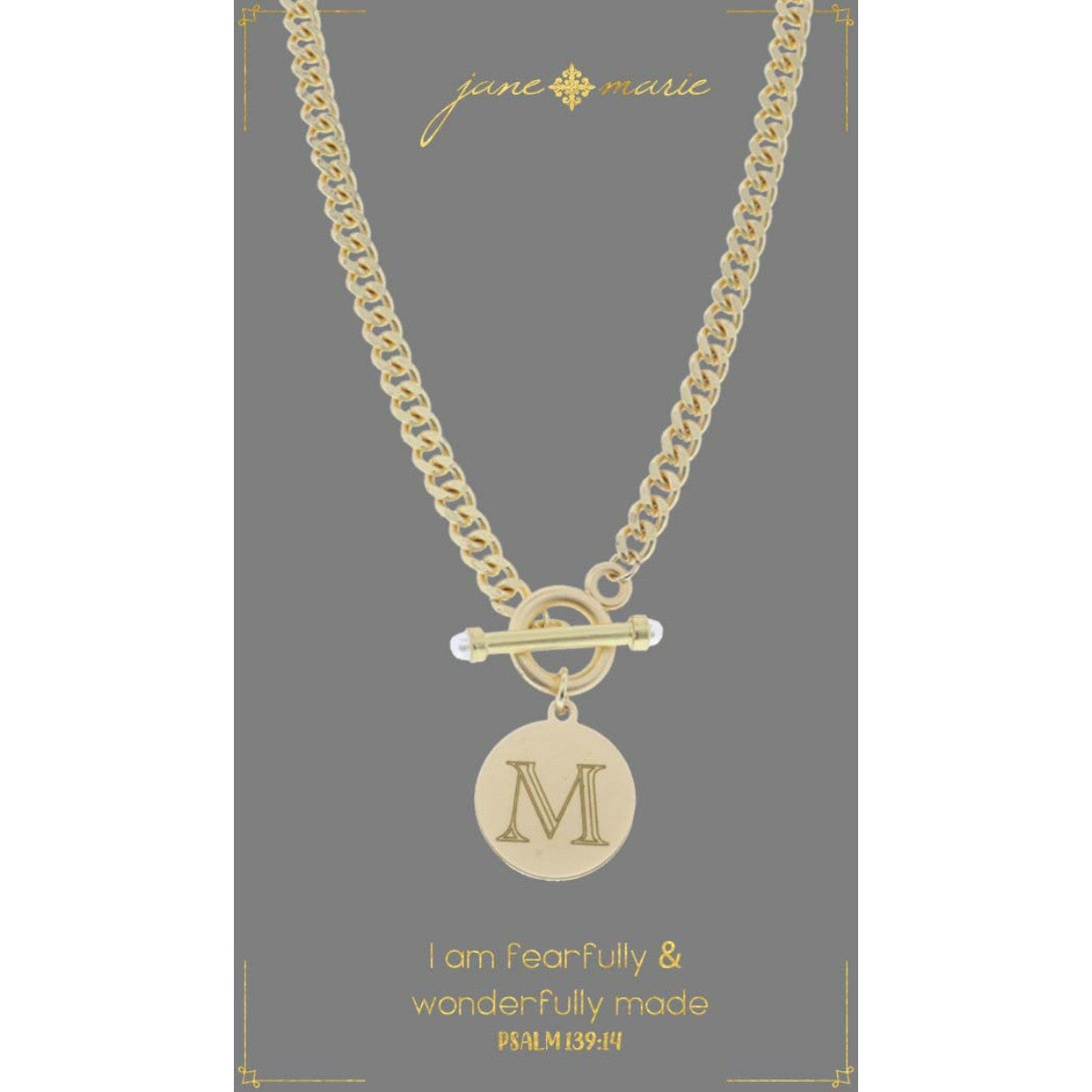 "m" stamped letter necklace on a gray display card on a white background