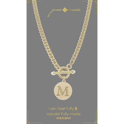 "m" stamped letter necklace on a gray display card on a white background