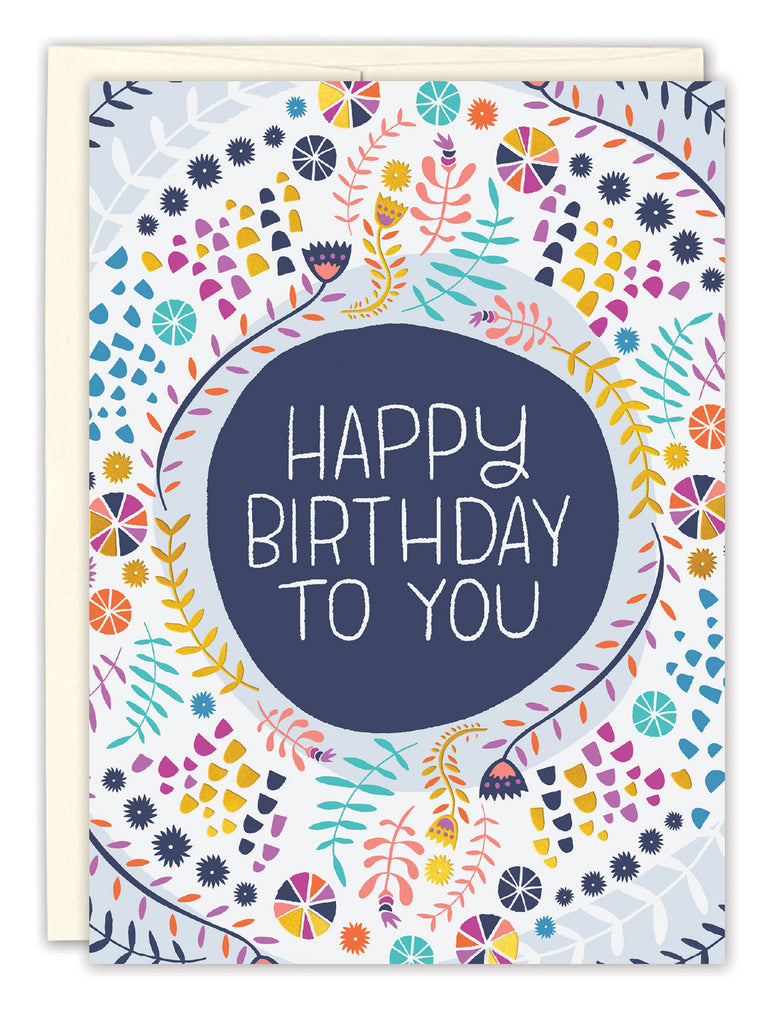 front of card is white with yellow, purple, navy, and turquoise designs all over with a navy circle in the center filled with text listed in the description with a with envelope on a white background
