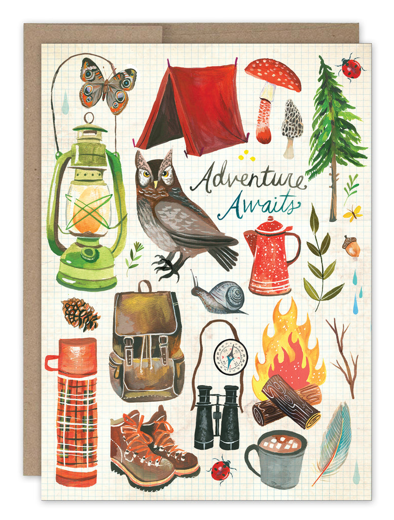 front cover of card is full of illustrations of camping gear, owl, trees, and campfire with a natural envelope behind it on a white background