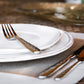 close-up of plates and silverware on tabletop.