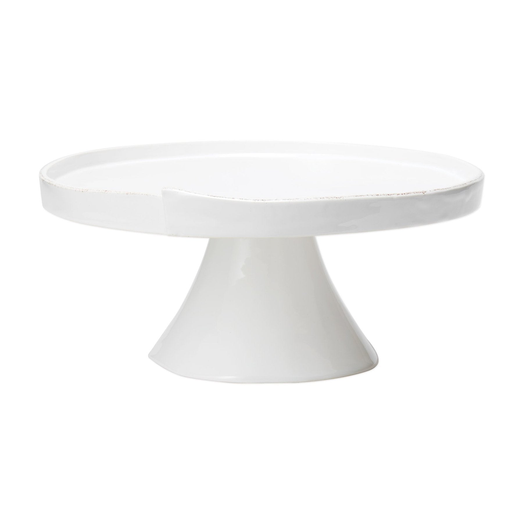 white cake stand with fluted pedestal and rimmed edge on white background.