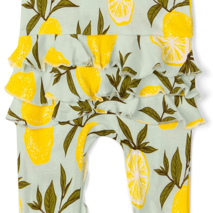 close up view of the ruffled bottom of the lemon ruffle footed romper displayed on a white background