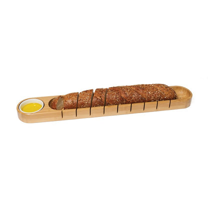 bamboo bread board and bowl with a sliced loaf of bread on a white background