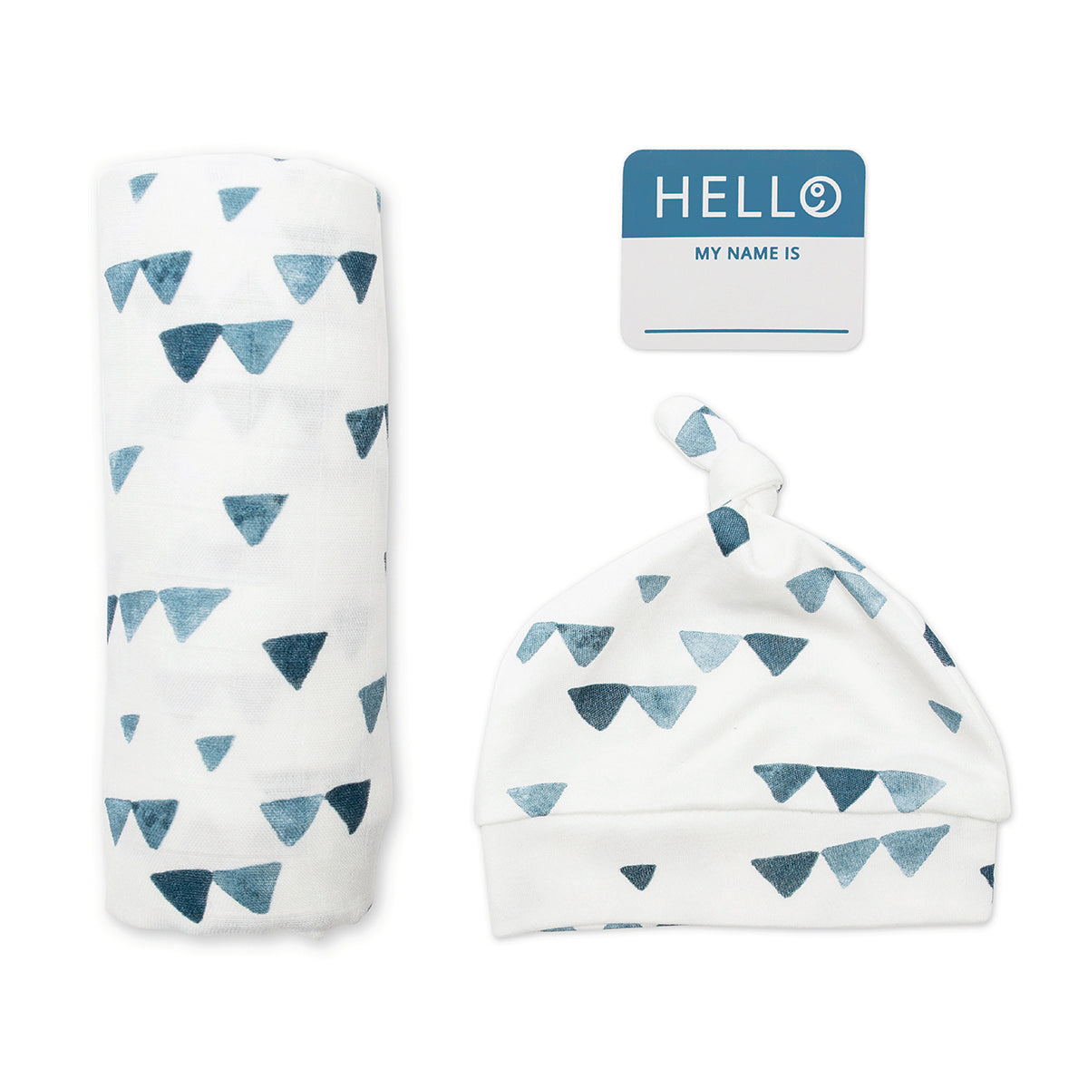 hello world hat, swaddle rolled up, and name tag displayed on a white background