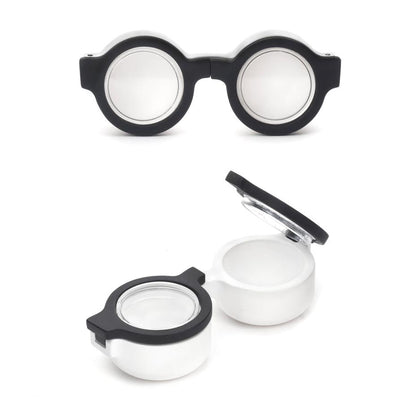 2 glasses shaped contact lens holders, one has a lid open.