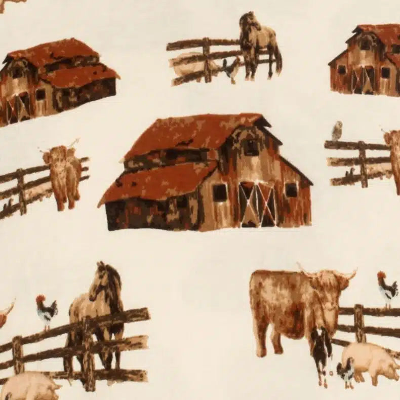 close-up of ivory fabric with all-over pattern of barns, horses, and cows.