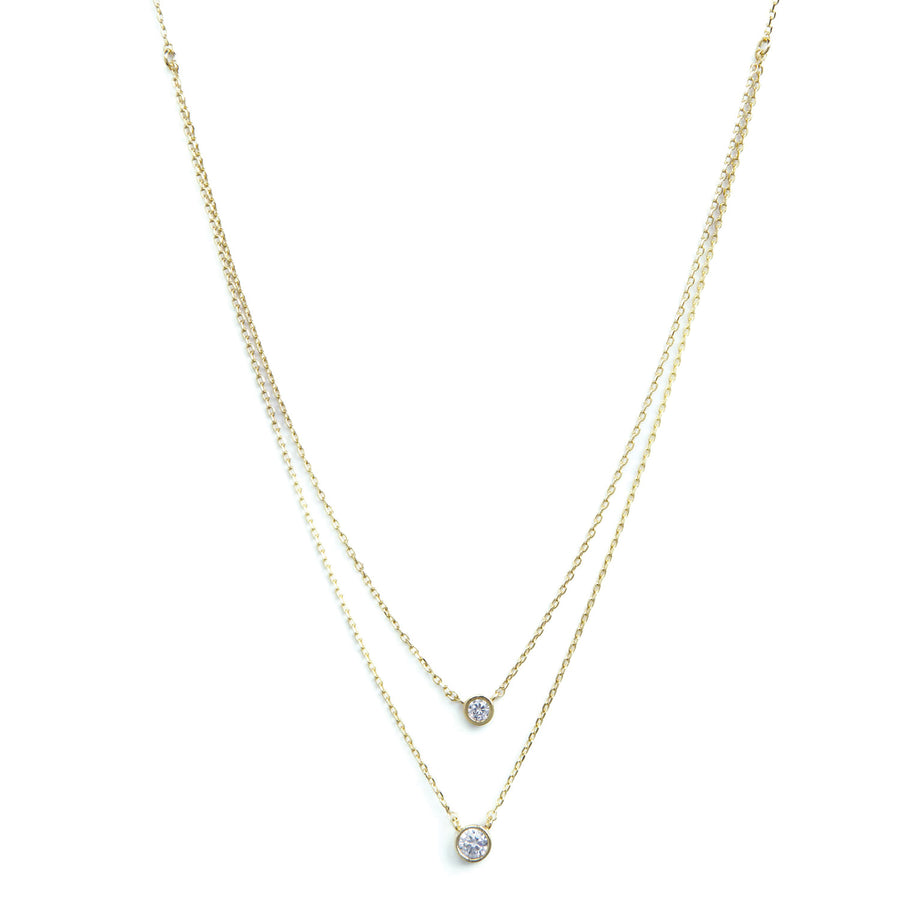 2 lengths on gold chains with mini and small cubic zirconia pendants.