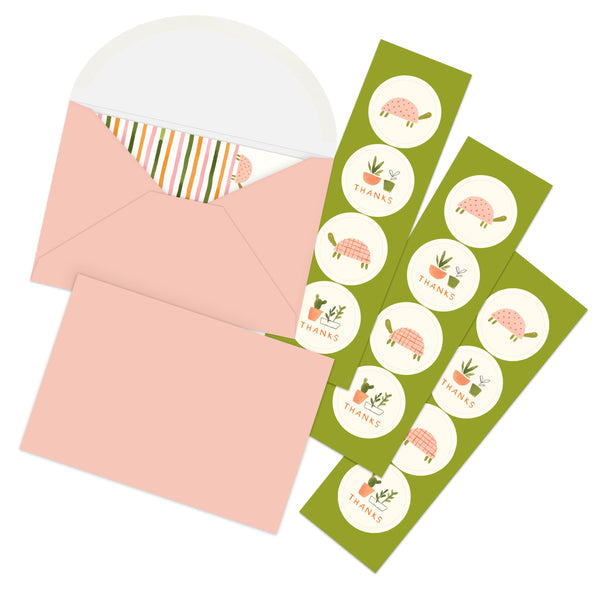 two blush pink envelopes and three sheets of stickers. stickers have either house plant graphic and the word "thanks" or a turtle graphic.