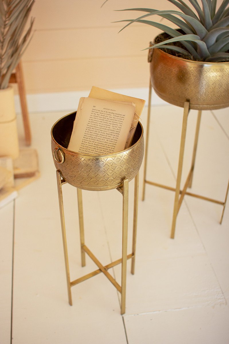 close-up of brass finished pot filled with papers.