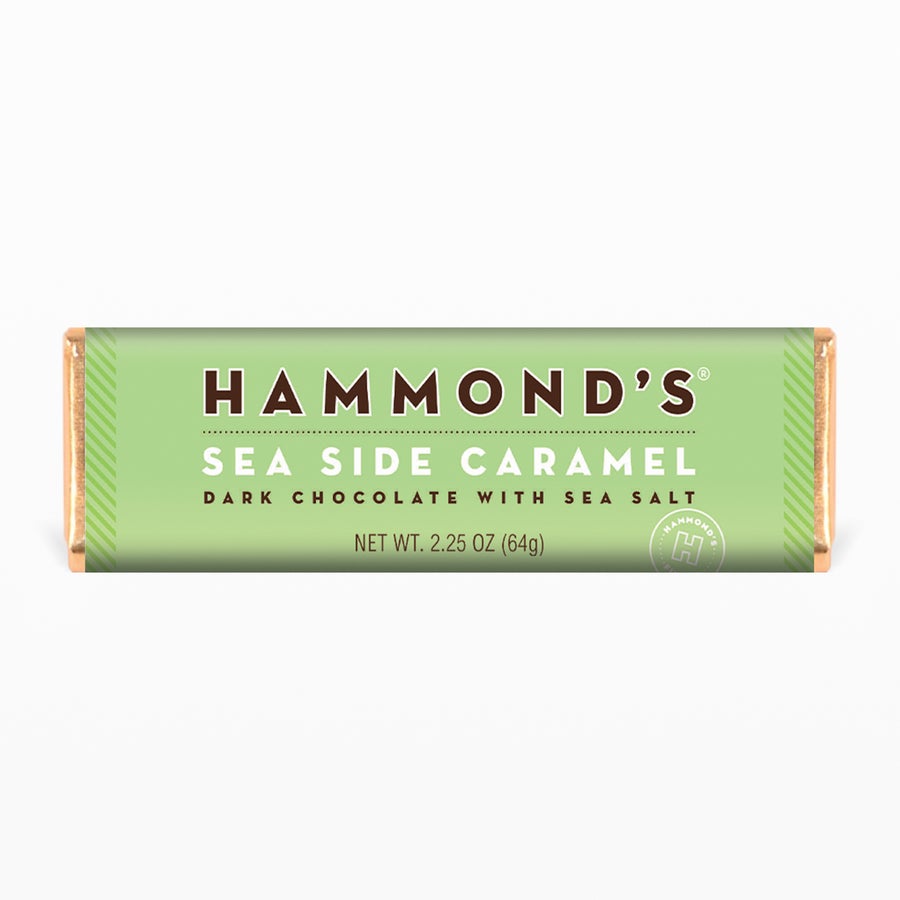 the natural sea side caramel dark chocolate candy bar on a pale green background