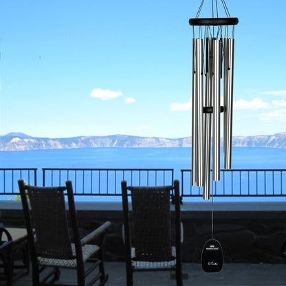 chime hanging on balcony with sea view in background.
